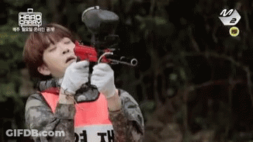 Man In Military Uniform Holding Paintball Gun GIF
