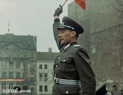 Man In Military Uniform Holding Red Flag With RSC GIF