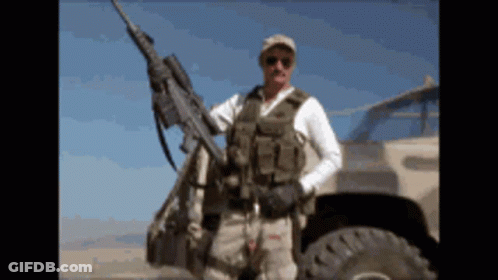 Man In Military Uniform Holding Rifle GIF