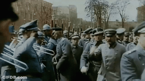 Man In Military Uniform Looking At Camera In Snow GIF