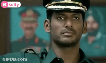 Man In Military Uniform Looking At Camera GIF