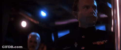 Man In Military Uniform Looking In Dark Room GIF