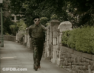 Man In Military Uniform Running Down Street GIF