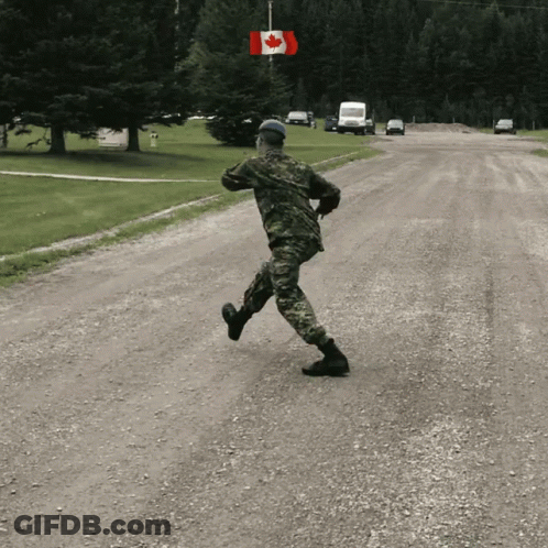 Man In Military Uniform Running With Canadian Flag GIF