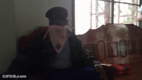 Man In Military Uniform Sitting By Window GIF
