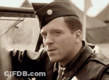 Man In Military Uniform Sitting In Car Looking Out Window GIF