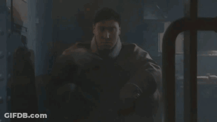 Man In Military Uniform Sitting In Dark Room GIF