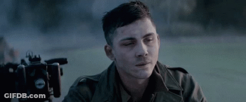 Man In Military Uniform Sitting In Front Of Camera GIF