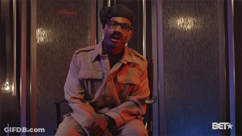 Man In Military Uniform Sitting With Bet Logo GIF