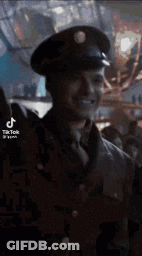Man In Military Uniform Smiling In Crowd GIF