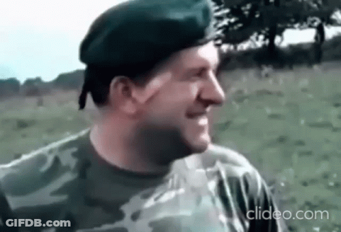 Man In Military Uniform Smiling In Field With Beret GIF