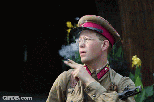 Man In Military Uniform Smoking Cigarette And Pointing GIF