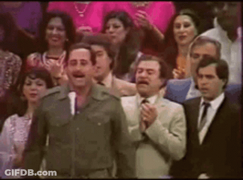Man In Military Uniform Standing Before Crowd In Suits GIF