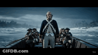 Man In Military Uniform Standing In Boat GIF