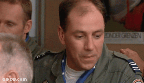 Man In Military Uniform Standing In Front Of Border Sign GIF