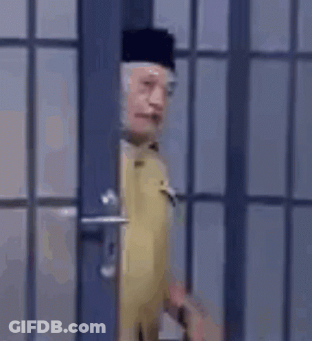 Man In Military Uniform Standing In Front Of Door GIF