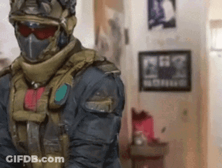Man In Military Uniform Standing In Room With Picture GIF