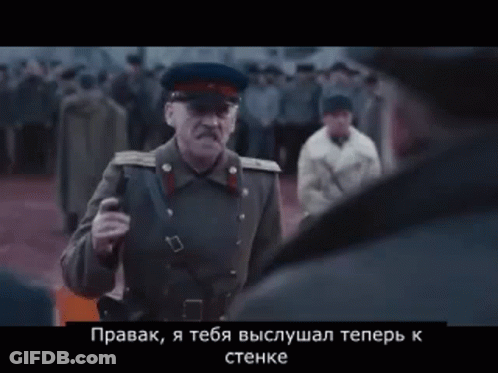 Man In Military Uniform Talking To Another In Crowd GIF