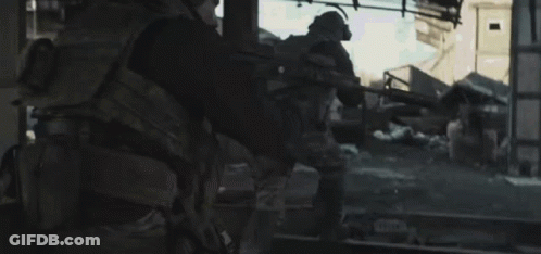 Man In Military Uniform Walking Down Street GIF