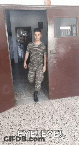Man In Military Uniform Walking Out Door With Eye Eye Above GIF