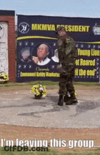 Man In Military Uniform With Flowers By MKMVA President Sign GIF