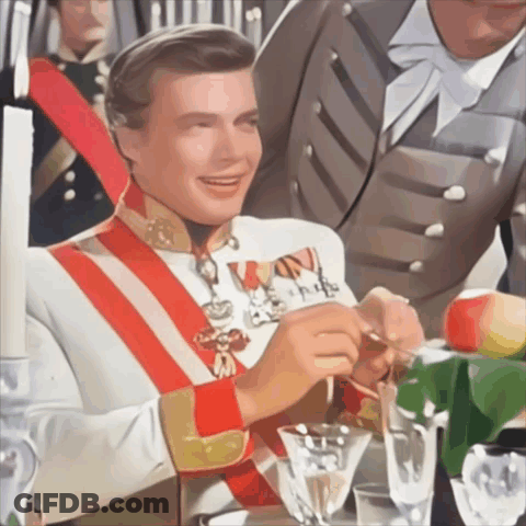 Man In Military Uniform With Red And White Sash Holding Spoon GIF