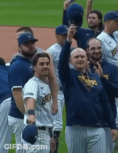 Man In Milwaukee Jersey Holding Baseball And Smiling GIF