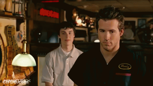 Man In Monday Shirt Next To Another Man GIF