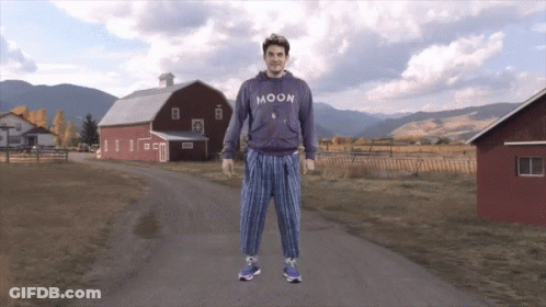 Man In Moon Sweatshirt In Front Of Barn GIF