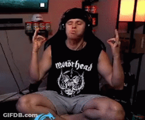 Man In Motörhead Tank Top Eyes Closed In Lotus Position GIF