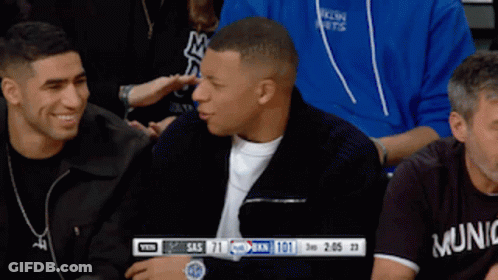 Man In Munich Shirt Sitting In Crowd GIF