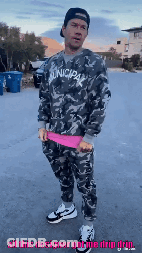 Man In Municipal Sweatshirt Standing On Street GIF