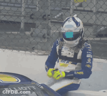 Man In Napa Helmet Sitting On Race Car GIF