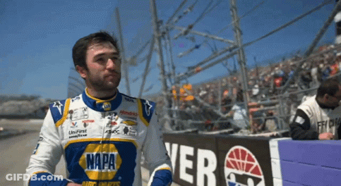 Man In Napa Jacket In Front Of Fence GIF