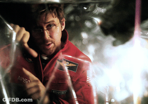 Man In NASA Jacket Looking Through Glass GIF