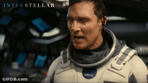 Man In NASA Space Suit Looking GIF
