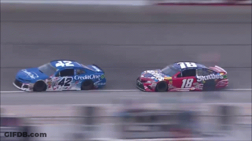 Man In Nascar Uniform Smiling Holding Snickers GIF