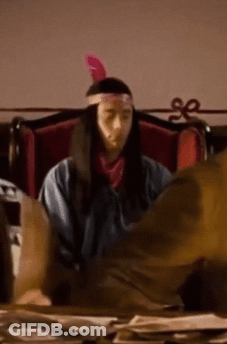Man In Native American Costume At Desk GIF