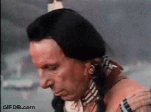 Man In Native American Costume Holding Shoulder Looking Down GIF