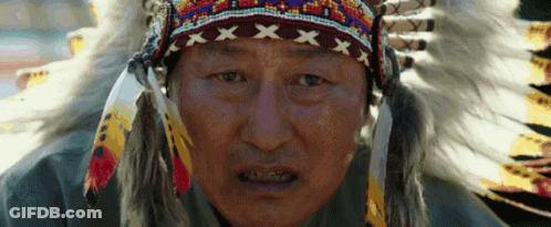 Man In Native American Headdress And Feathers GIF