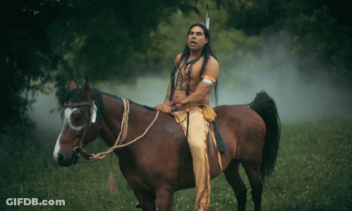 Man In Native American Outfit Rides Horse GIF