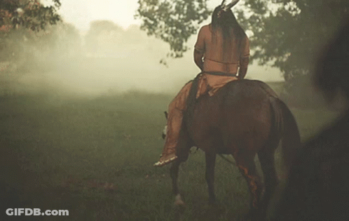 Man In Native American Outfit Riding Horse GIF