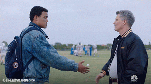 Man In NBC Jacket Talking On Football Field GIF