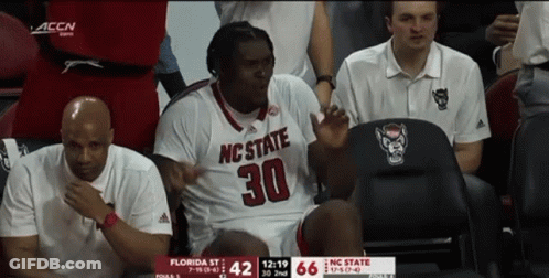 Man In NC State Jersey Sitting In Chair GIF