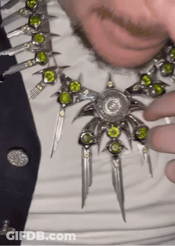 Man In Necklace With Green Stones And Black Tie GIF