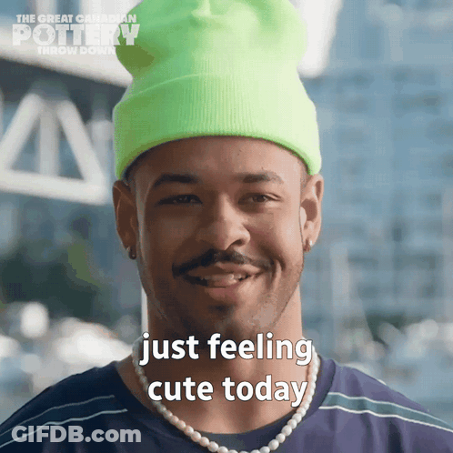 Man In Neon Green Beanie And Pearls Saying Just Feeling Cute Today GIF
