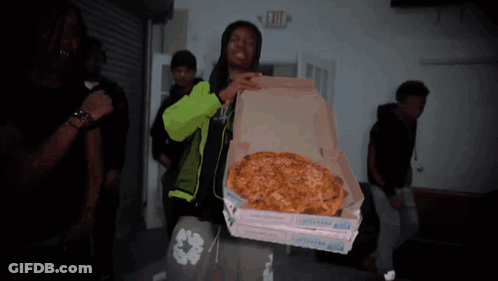 Man In Neon Green Jacket Holding Pizza Box GIF