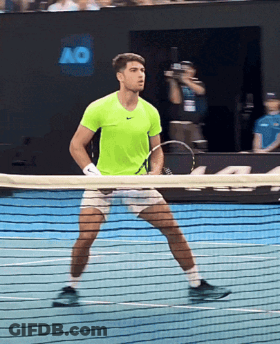 Man In Neon Green Shirt Holding Tennis Racquet GIF