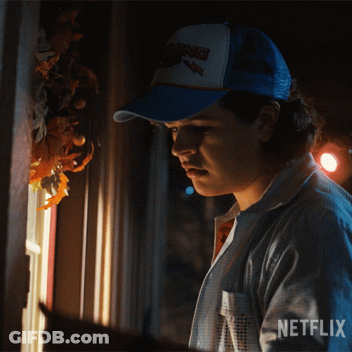Man In Netflix Hat Looking Out Window At Night GIF