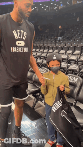 Man In Nets Basketball Shirt Talks To Boy GIF